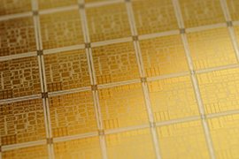 close up of a gold semiconductor wafer